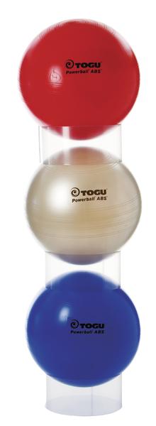 Drei TOGU Powerball ABS Gymnastikbälle in Rot, Beige und Blau gestapelt.