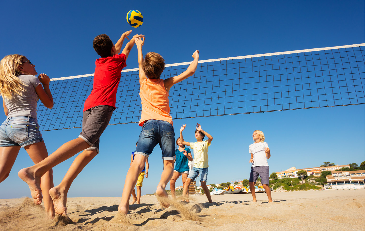 Kinder spielen Ball über ein Netz